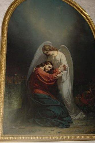 Taulu, jossa enkeli lohduttaa Jeesusta Getsemanen puutarhassa. Enkeli halaa Jeesusta. Kullanväriset kehykset.